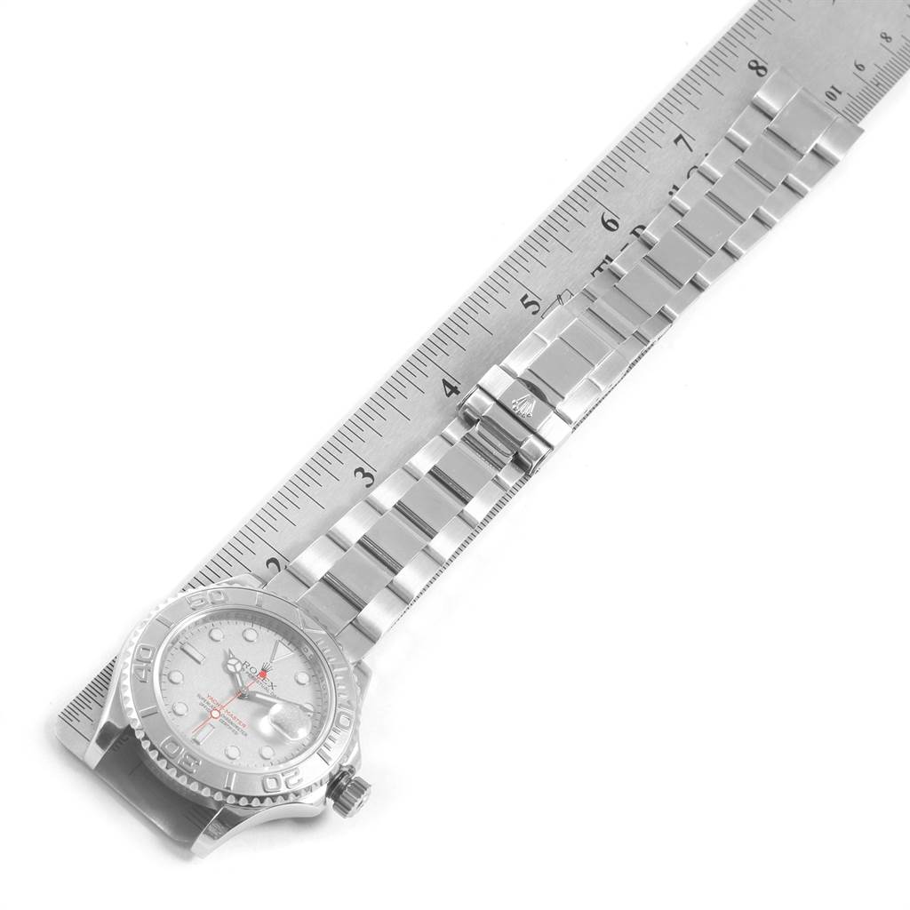 The image shows a top-down view of a Rolex Yacht-Master 16622 Men's Stainless Steel Silver Dial 16622 Men's Stainless Steel Silver Dial watch, highlighting the face, bezel, and bracelet next to a ruler.