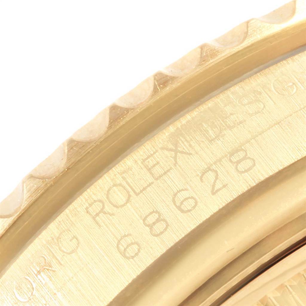 This close-up image shows the edge of the bezel and engraving on a Rolex Yacht-Master 68628 Men
s Yellow Gold Mother of Pearl Dial 68628 Men
s Yellow Gold Mother of Pearl Dial watch.