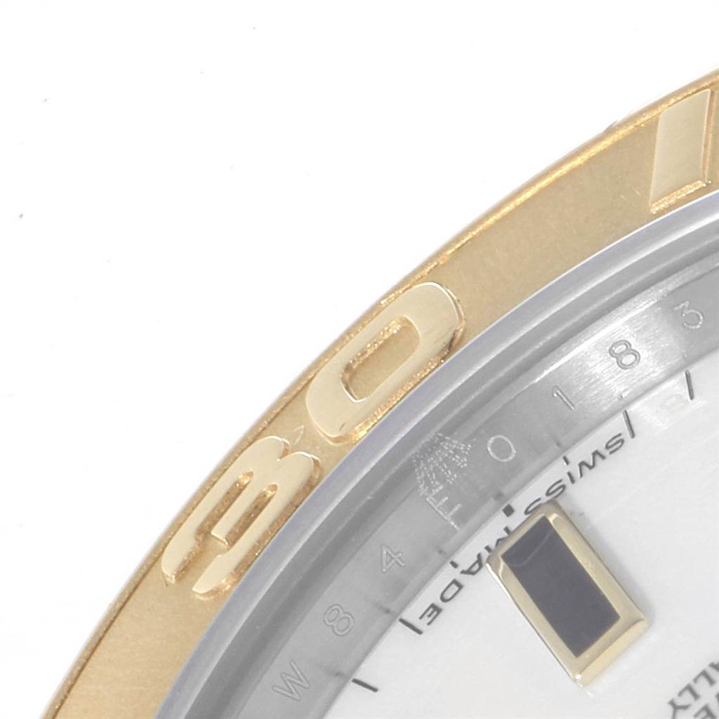The image shows a close-up of the bezel and part of the face of a Rolex Yacht-Master 168623 Men
s Steel and Gold (two tone) White Dial 168623 Men
s Steel and Gold (two tone) White Dial watch.