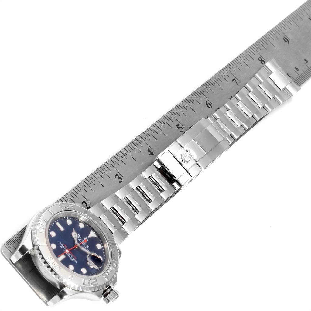The image shows a Rolex Yacht-Master 116622 Men
s Stainless Steel Blue Dial 116622 Men
s Stainless Steel Blue Dial watch laid flat with a ruler, displaying the watch face, bezel, and metal bracelet.