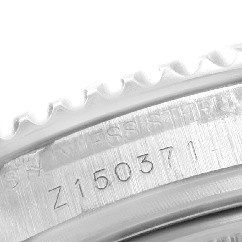 The image shows a close-up of the engraved serial number and knurled edge on a Rolex Yacht-Master 168622 Men
s Stainless Steel Silver Dial 168622 Men
s Stainless Steel Silver Dial watch.