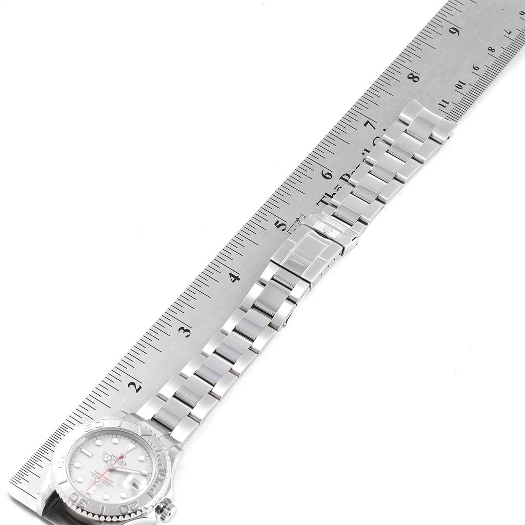 The image shows a side view of a Rolex Yacht-Master 168622 Men
s Stainless Steel Silver Dial 168622 Men
s Stainless Steel Silver Dial watch next to a ruler, highlighting the watch
s bracelet and clasp.