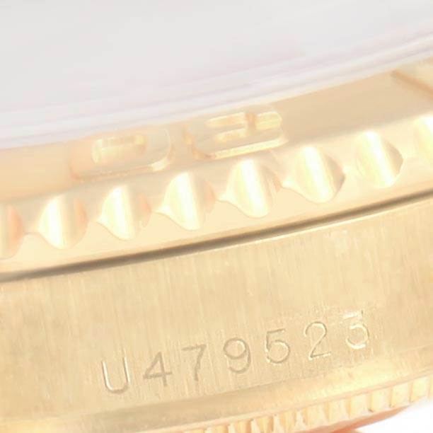 This image shows a close-up of the serial number and part of the bezel of a Rolex Yacht-Master 68628 Yellow Gold Blue Dial 68628 Yellow Gold Blue Dial watch.