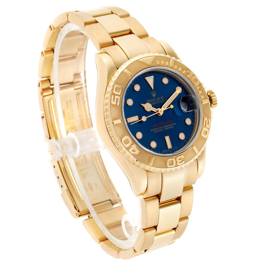 The image shows a side angle of the Rolex Yacht-Master 68628 Yellow Gold Blue Dial 68628 Yellow Gold Blue Dial watch, highlighting its gold bracelet, blue dial, and bezel.