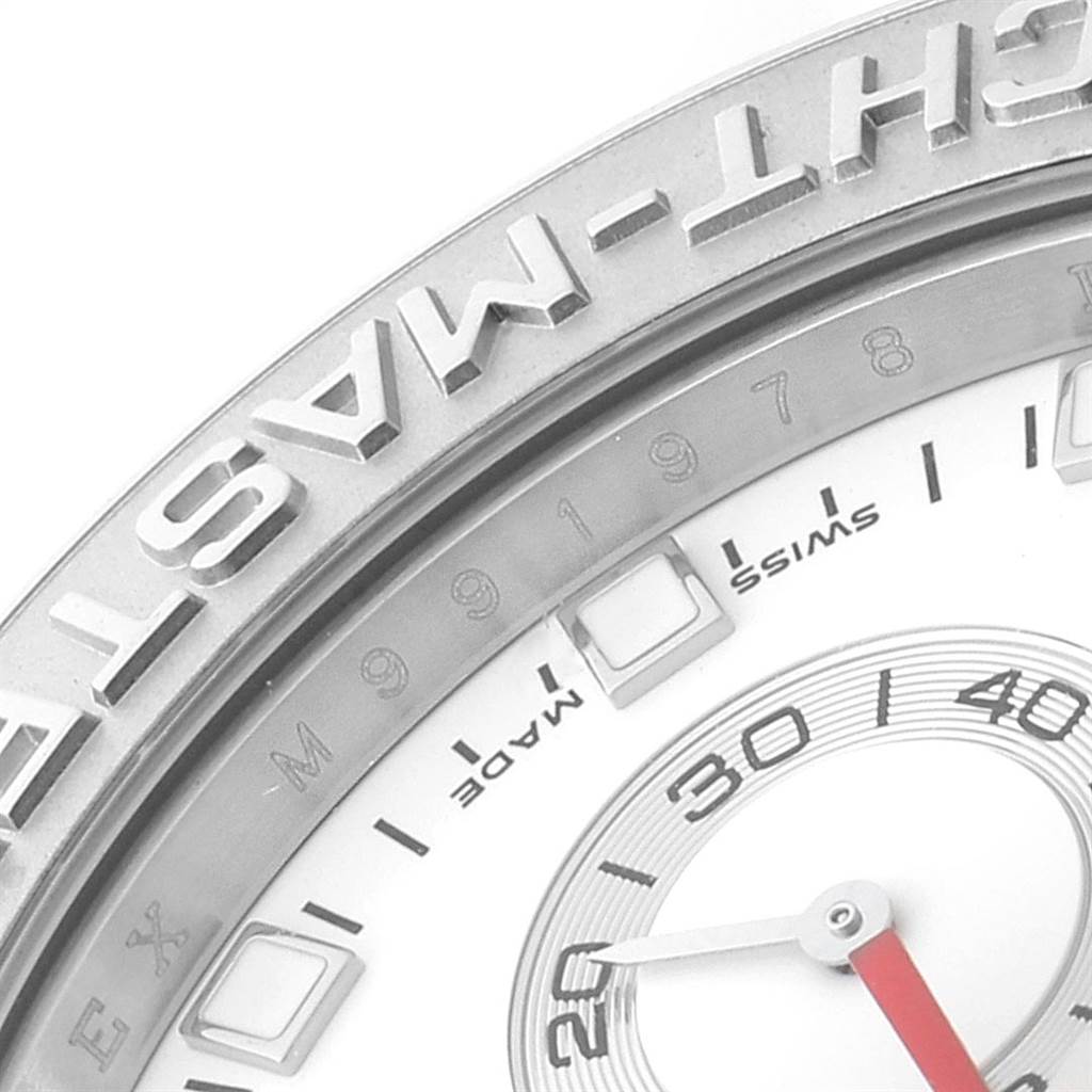 This close-up image shows the bezel, part of the dial, and hands of a Rolex Yacht-Master 116689 Men's White Gold White Dial 116689 Men's White Gold White Dial watch.