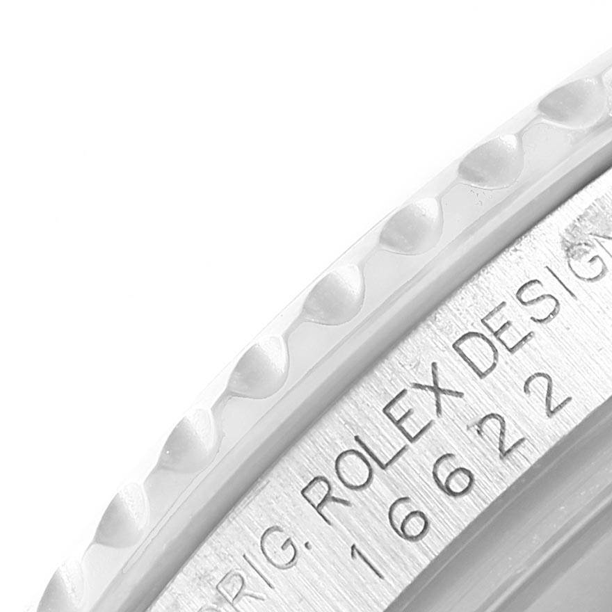 This image shows a close-up of the Rolex Yacht-Master 16622 Men's Stainless Steel Silver Dial 16622 Men's Stainless Steel Silver Dial bezel and part of the engraved case back.