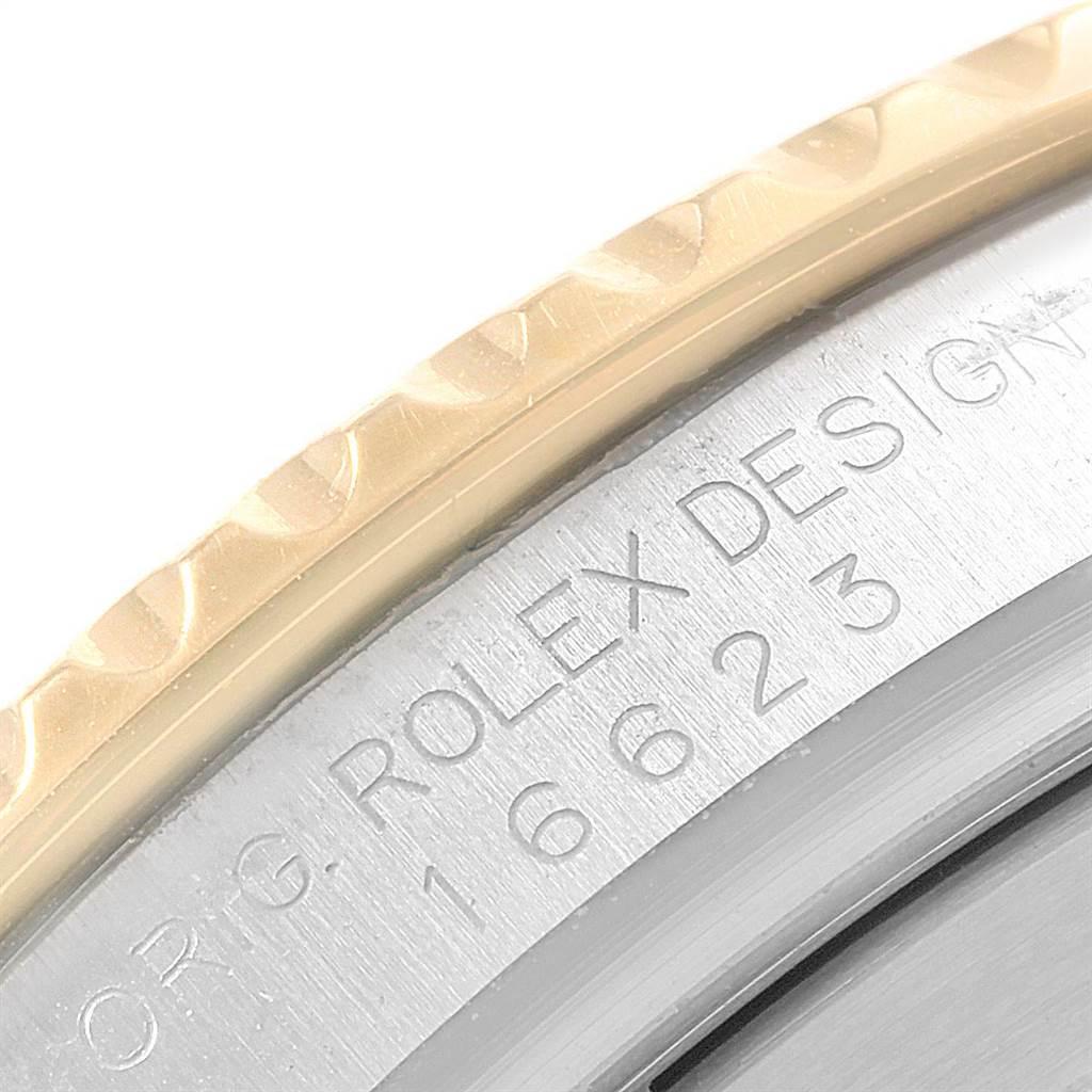 This close-up image of a Rolex Yacht-Master 16623 Men's Stainless Steel Blue Dial 16623 Men's Stainless Steel Blue Dial watch shows part of the engraved case and bezel.