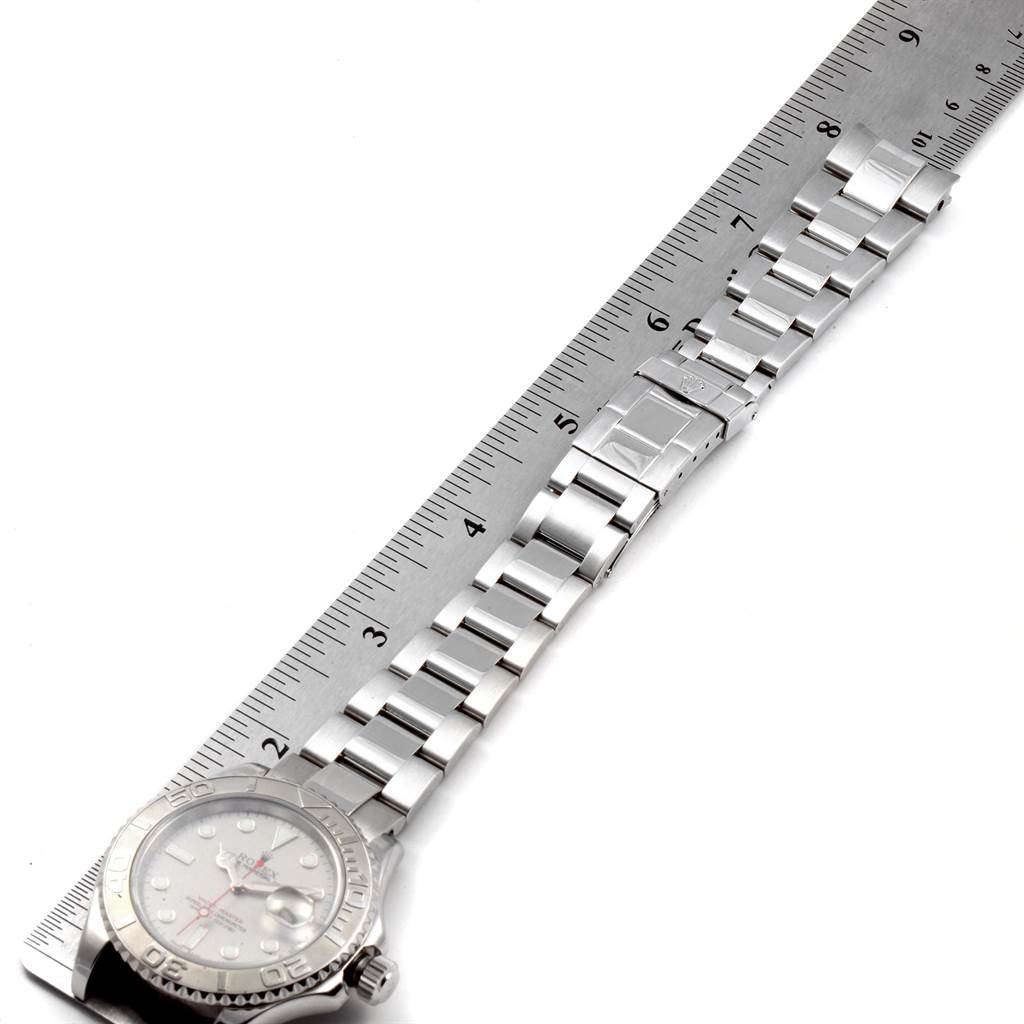 The image shows a Rolex Yacht-Master 16622 Men's Stainless Steel Silver Dial 16622 Men's Stainless Steel Silver Dial watch laid flat with a metal ruler along its bracelet.