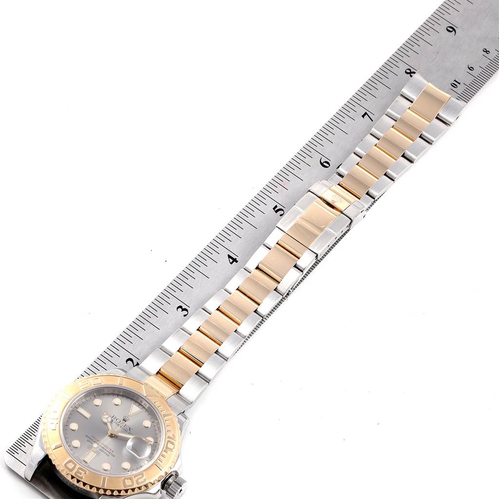 This image shows a Rolex Yacht-Master 16623 Men's Steel and Gold (two tone) Grey Dial 16623 Men's Steel and Gold (two tone) Grey Dial watch positioned horizontally with its bracelet aligned against a ruler.
