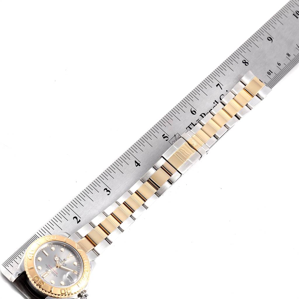 This image displays the Rolex Yacht-Master 168623 Men
s Steel and Gold (two tone) Grey Dial 168623 Men
s Steel and Gold (two tone) Grey Dial watch face and bracelet, shown next to a ruler for scale.