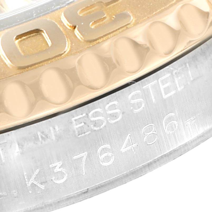 This close-up angle of the Rolex Yacht-Master 168623 Men
s Steel and Gold (two tone) Grey Dial 168623 Men
s Steel and Gold (two tone) Grey Dial watch shows part of the gold bezel and the engraved stainless steel case.