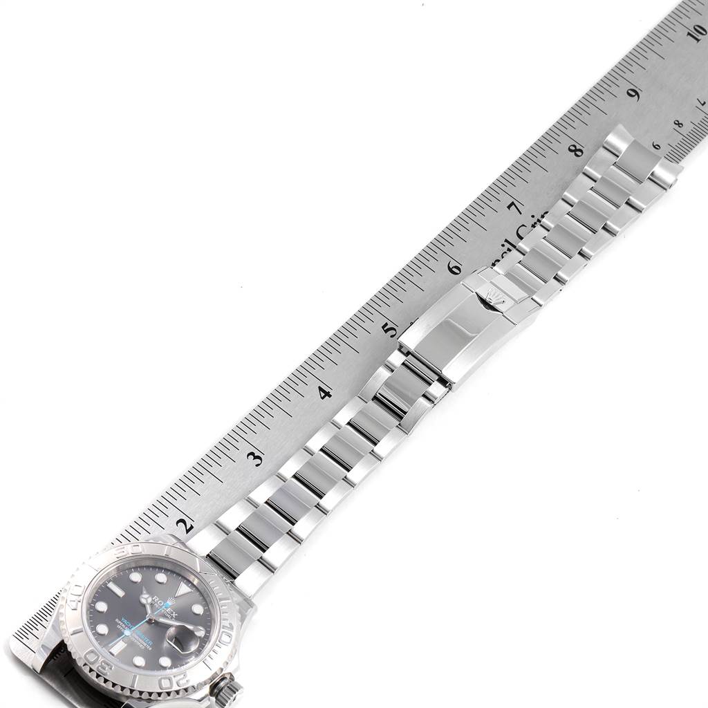 The image shows a side view of a Rolex Yacht-Master 116622 Men's Stainless Steel Grey Dial 116622 Men's Stainless Steel Grey Dial watch, including the band and clasp, alongside a ruler for scale.