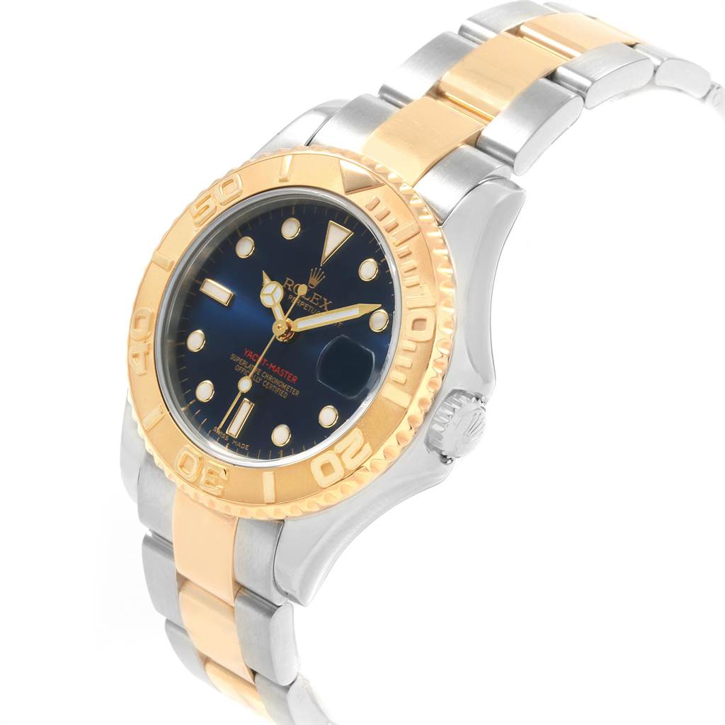 The image shows a Rolex Yacht-Master 168623 Men's Steel and Gold (two tone) Blue Dial 168623 Men's Steel and Gold (two tone) Blue Dial watch at an angle highlighting its gold bezel, blue dial, and two-tone metal bracelet.