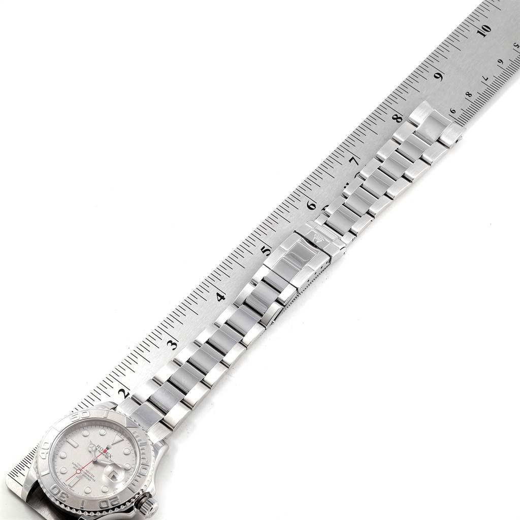 The image shows a Rolex Yacht-Master 16622 Men's Stainless Steel Silver Dial 16622 Men's Stainless Steel Silver Dial watch lying flat with its metal bracelet extended alongside a ruler.