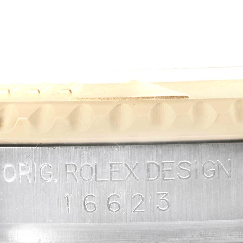 This image shows a close-up of the bezel and the engraved case side of a Rolex Yacht-Master 16623 Men's Stainless Steel Champagne Dial 16623 Men's Stainless Steel Champagne Dial watch, including the model number 16623.