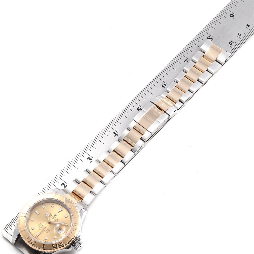 The image shows a Rolex Yacht-Master 16623 Men's Stainless Steel Champagne Dial 16623 Men's Stainless Steel Champagne Dial watch laid against a ruler, showcasing the face and bracelet at a slight diagonal angle.