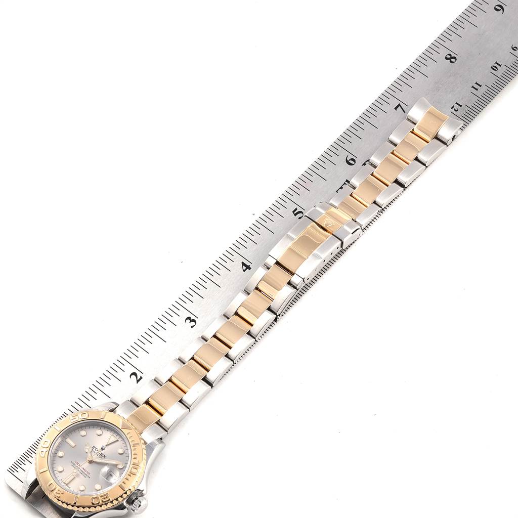 The image shows a Rolex Yacht-Master 168623 Men
s Steel and Gold (two tone) Grey Dial 168623 Men
s Steel and Gold (two tone) Grey Dial watch laid flat with a metal ruler beside it, displaying its band and face.