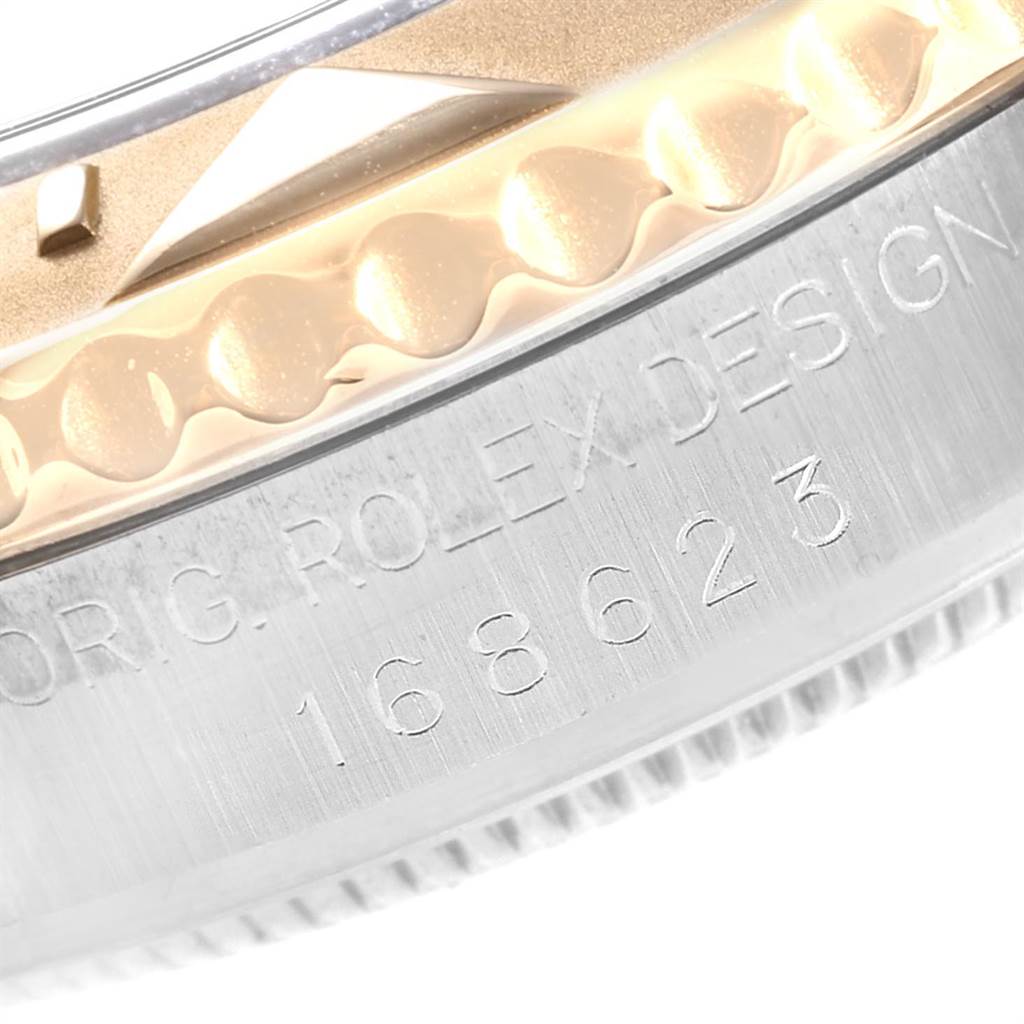 This close-up image shows the side of a Rolex Yacht-Master 168623 Men
s Steel and Gold (two tone) Grey Dial 168623 Men
s Steel and Gold (two tone) Grey Dial watch, focusing on the bezel and engraved model number.