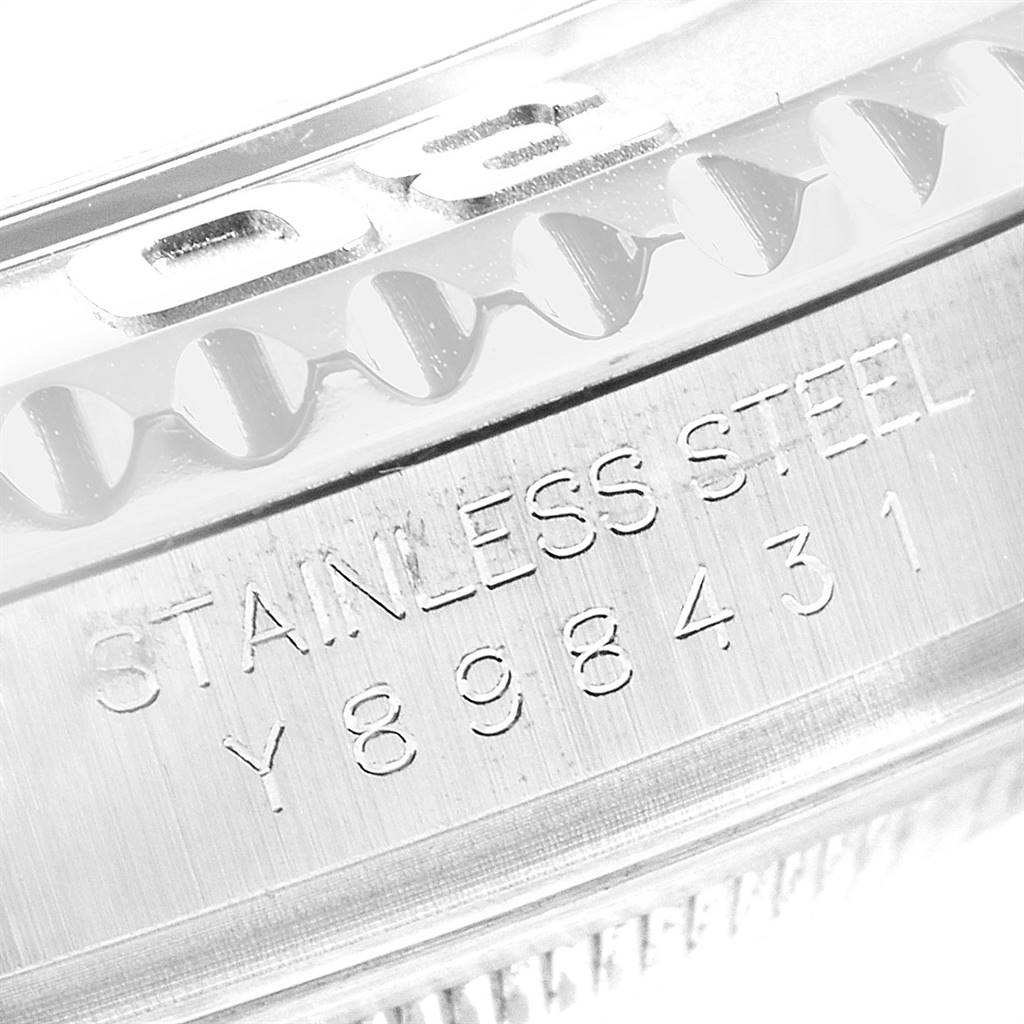 This image shows a close-up of the stainless steel part of a Rolex Yacht-Master 16622 Men's Stainless Steel Silver Dial 16622 Men's Stainless Steel Silver Dial watch, highlighting its serial number and bezel.