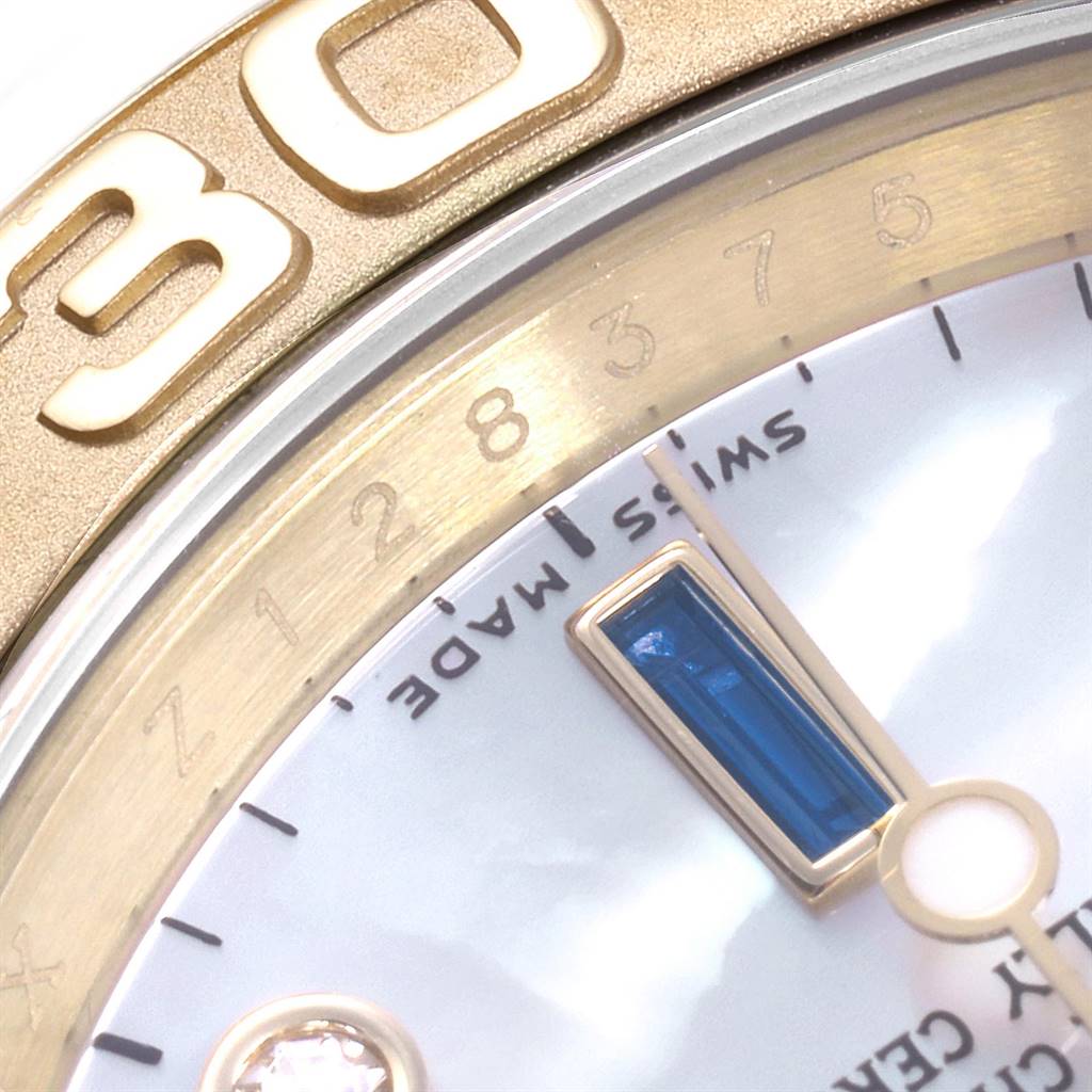 The image shows a close-up view of the Rolex Yacht-Master 16628 Men
s Yellow Gold Mother of Pearl Dial 16628 Men
s Yellow Gold Mother of Pearl Dial watch
s bezel and part of its dial.