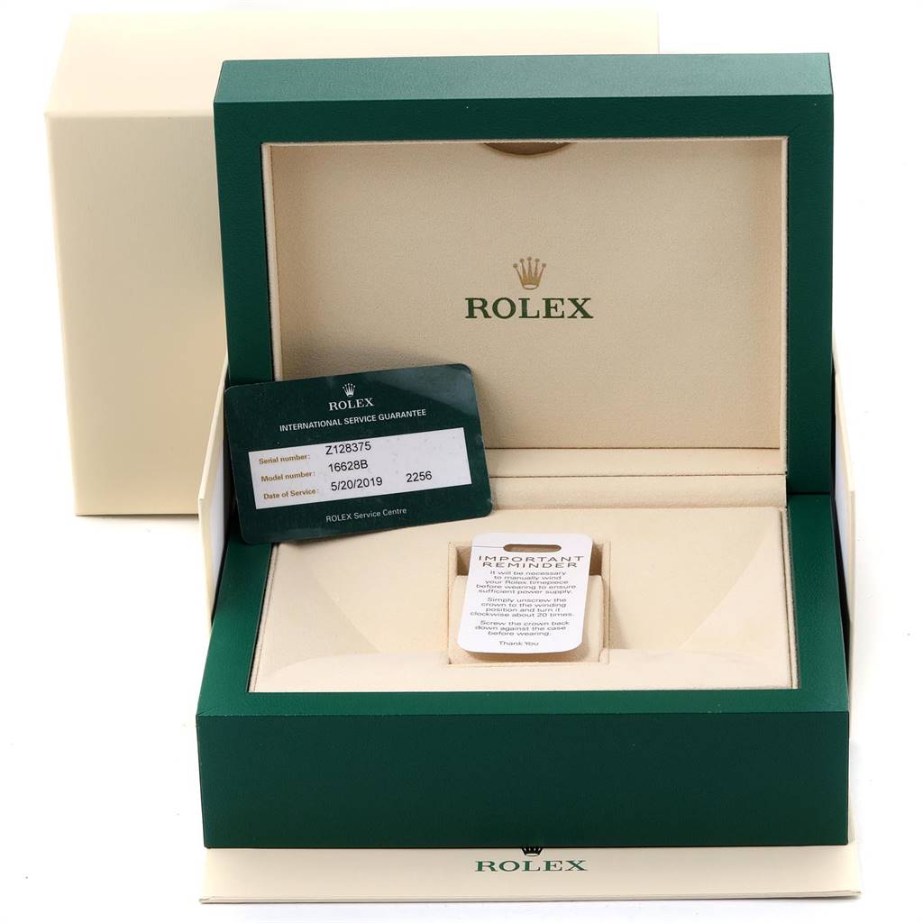 The image shows a Rolex Yacht-Master 16628 Men
s Yellow Gold Mother of Pearl Dial 16628 Men
s Yellow Gold Mother of Pearl Dial watch box open, displaying a guarantee card with model information inside.
