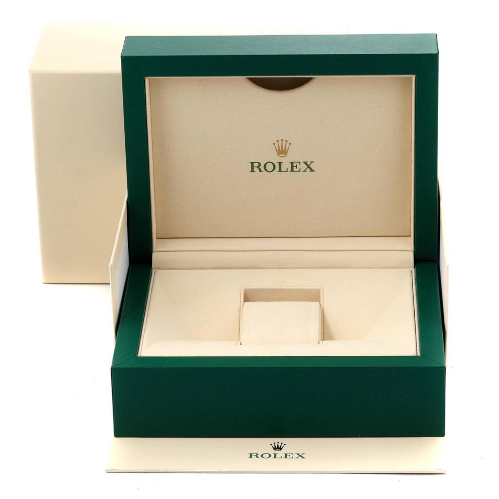 The image shows an open Rolex box for the Yacht-Master model, focusing on its beige interior and green exterior.