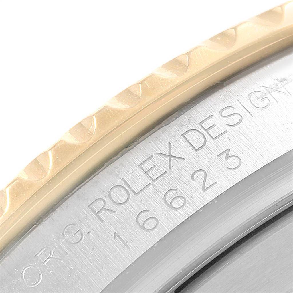This close-up image of the Rolex Yacht-Master 16623 Men's Stainless Steel Blue Dial 16623 Men's Stainless Steel Blue Dial watch shows part of the bezel and a section with the model number engraved.