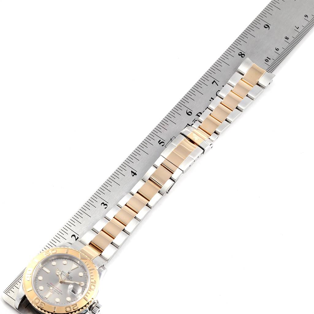 The image shows a Rolex Yacht-Master 16623 Men's Stainless Steel Grey Dial 16623 Men's Stainless Steel Grey Dial watch, focusing on its bracelet and partially on its face, alongside a ruler for size reference.