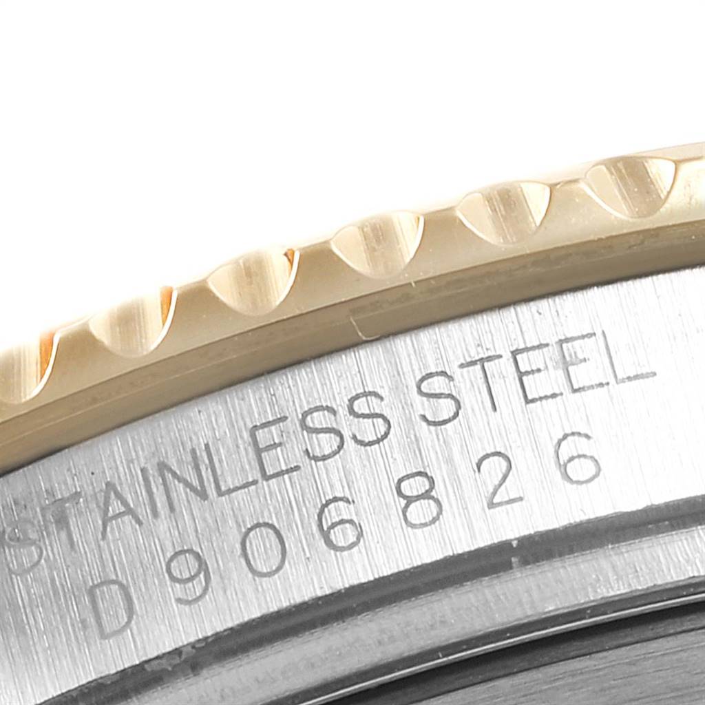 The image shows a close-up of a Rolex Yacht-Master 16623 Men's Stainless Steel Mother of Pearl Dial 16623 Men's Stainless Steel Mother of Pearl Dial watch's bezel and part of the stainless steel case with engraving.