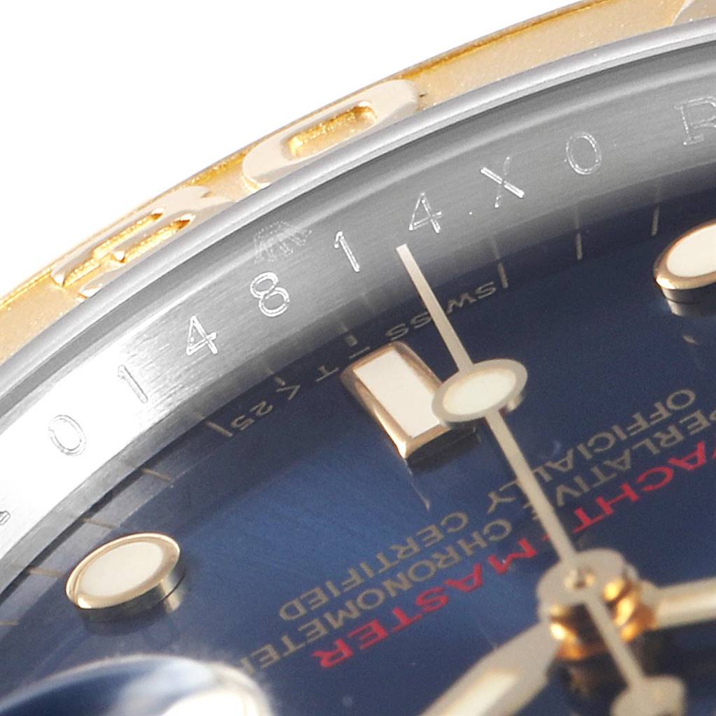 This close-up image of the Rolex Yacht-Master 16623 Men's Stainless Steel Blue Dial 16623 Men's Stainless Steel Blue Dial watch shows a portion of the bezel, dial, and crystal.