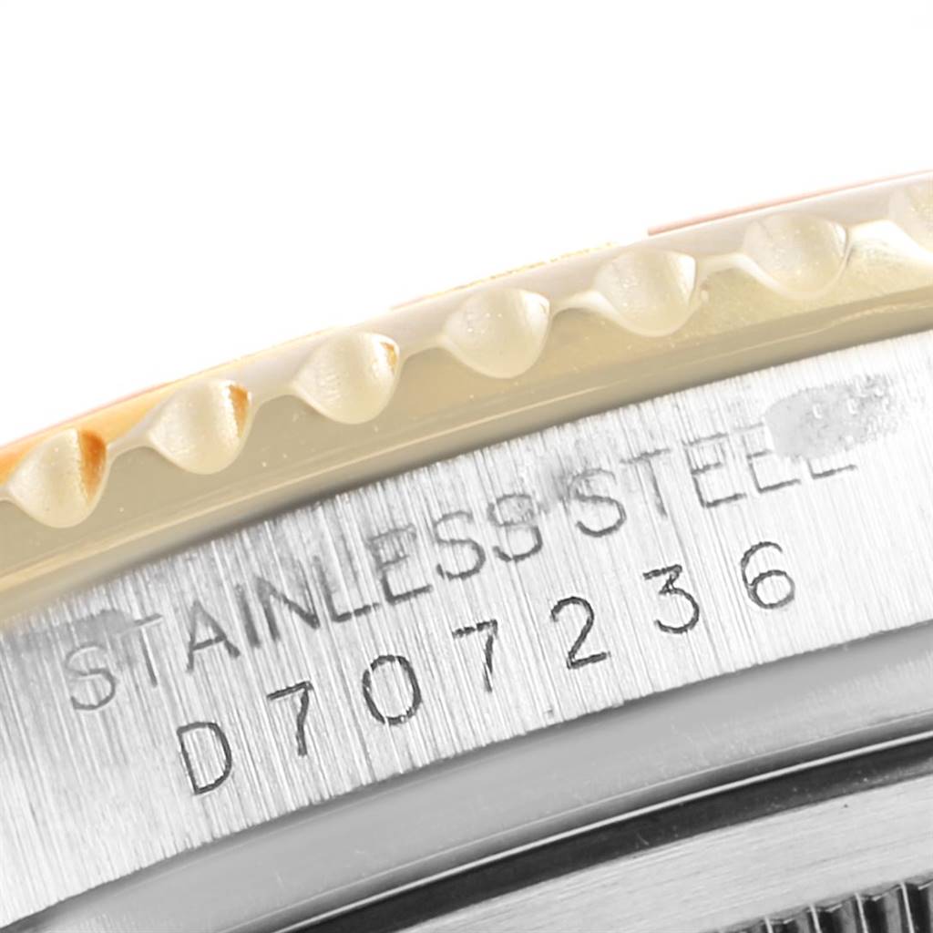 This close-up angle of the Rolex Yacht-Master 16623 Men's Stainless Steel Blue Dial 16623 Men's Stainless Steel Blue Dial watch displays the engraved serial number on its stainless steel case edge.