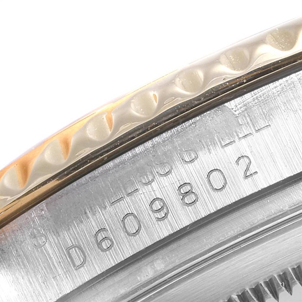 This image shows a close-up of the side of a Rolex Yacht-Master 16623 Men's Stainless Steel Blue Dial 16623 Men's Stainless Steel Blue Dial watch, featuring its bezel and serial number.
