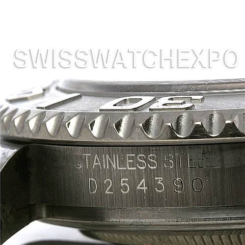This close-up image of the Rolex Yacht-Master 16622 Men's Stainless Steel Silver Dial 16622 Men's Stainless Steel Silver Dial shows the watch's bezel and part of the stainless steel case with serial number engraving.