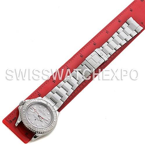 The Rolex Yacht-Master 16622 Men's Stainless Steel Silver Dial 16622 Men's Stainless Steel Silver Dial watch is shown laid flat next to a red measuring ruler, displaying the face, bezel, and bracelet.