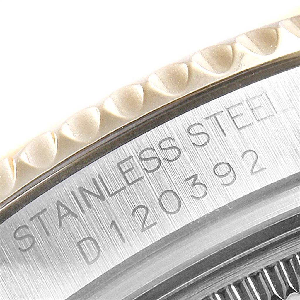 This close-up image shows the textured bezel and part of the engraved back case of a Rolex Yacht-Master 168623 Men's Steel and Gold (two tone) White Dial 168623 Men's Steel and Gold (two tone) White Dial watch.