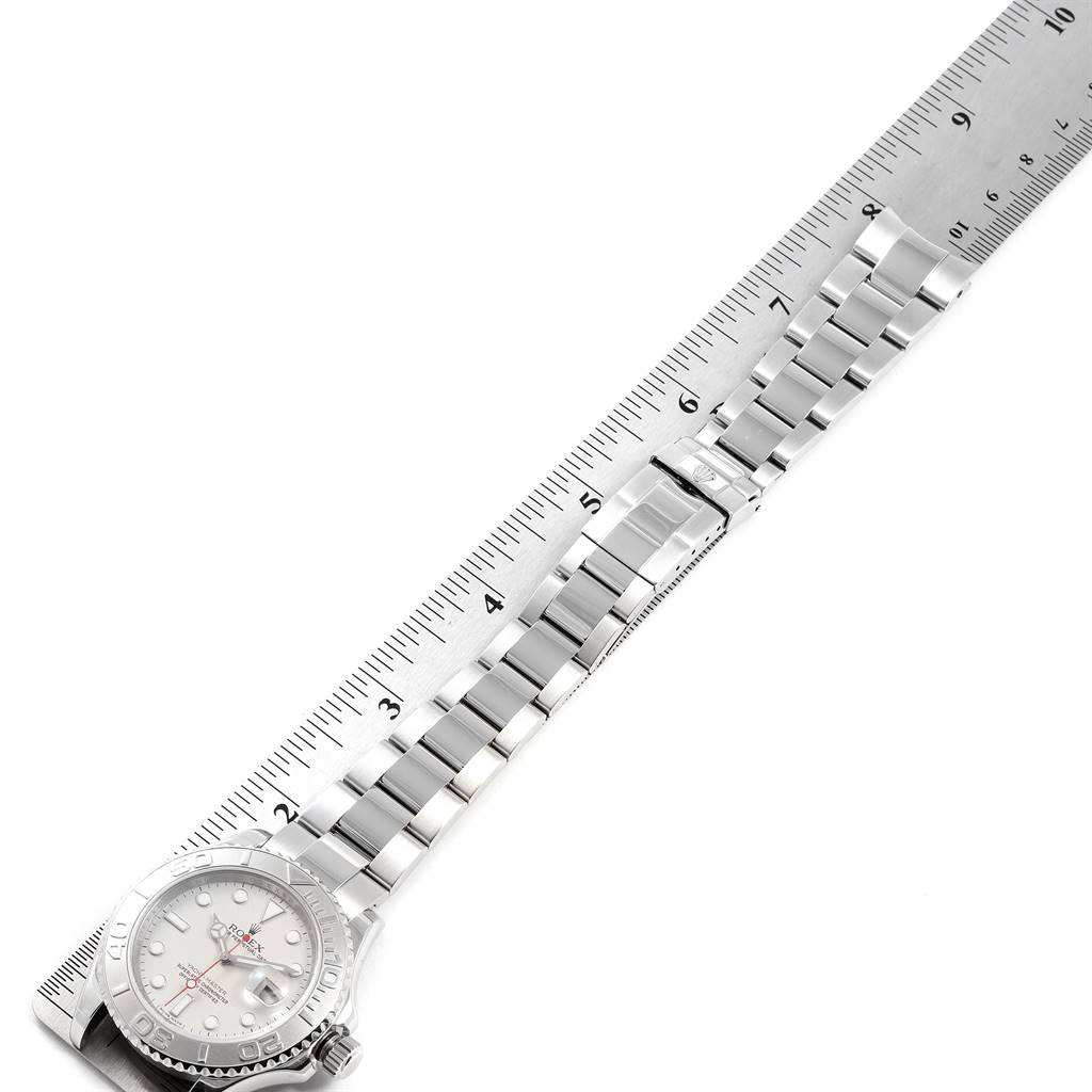 The image shows a Rolex Yacht-Master 16622 Men
s Stainless Steel Silver Dial 16622 Men
s Stainless Steel Silver Dial watch laid flat beside a ruler, highlighting its bracelet and face.