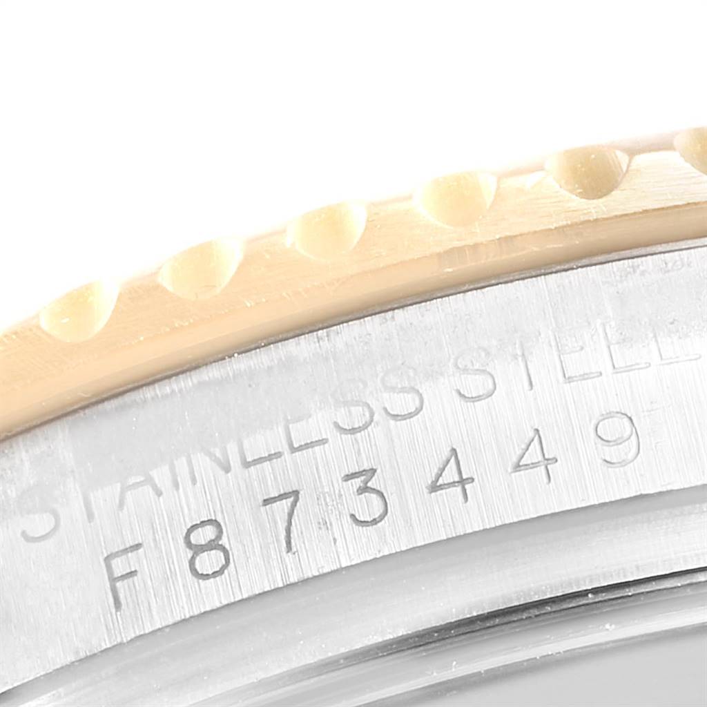 This close-up image shows the engraved serial number and part of the bezel on a Rolex Yacht-Master 16623 Men's Stainless Steel Champagne Dial 16623 Men's Stainless Steel Champagne Dial watch.