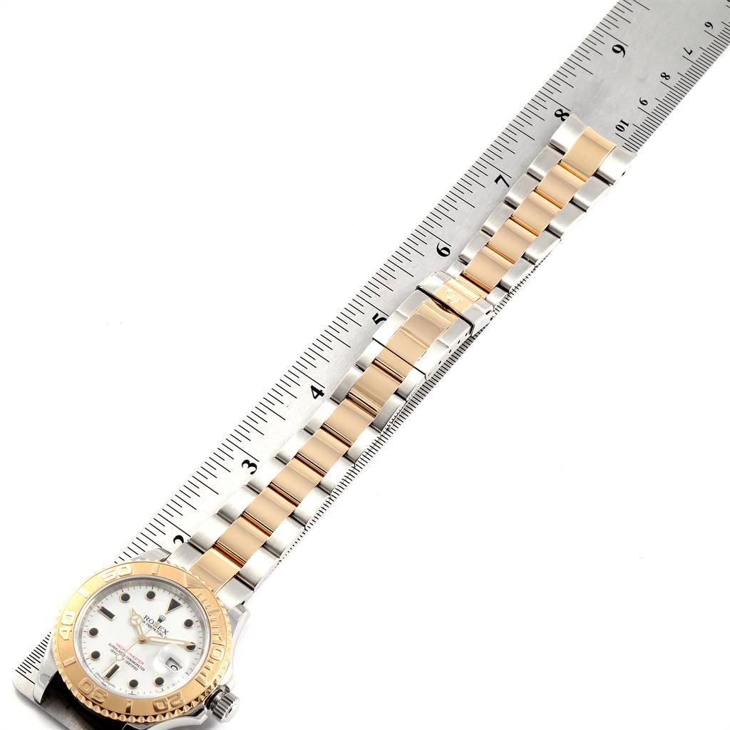 The image shows a Rolex Yacht-Master 16623 Men
s Stainless Steel White Dial 16623 Men
s Stainless Steel White Dial watch laid flat, with a ruler measuring the length of its metal strap.