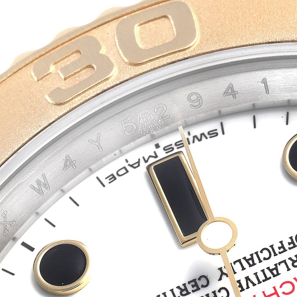 This close-up image of the Rolex Yacht-Master 16623 Men
s Stainless Steel White Dial 16623 Men
s Stainless Steel White Dial watch shows part of the bezel, dial, and hour markers.