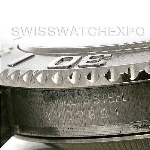 This close-up image of the Rolex Yacht-Master 16622 Men's Stainless Steel Silver Dial 16622 Men's Stainless Steel Silver Dial watch shows its stainless steel bezel and part of the case with engraved serial number.