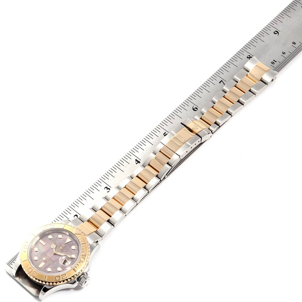 The image shows a Rolex Yacht-Master 16623 Men's Stainless Steel Mother of Pearl Dial 16623 Men's Stainless Steel Mother of Pearl Dial watch laid flat, with a fully extended two-tone bracelet next to a ruler.