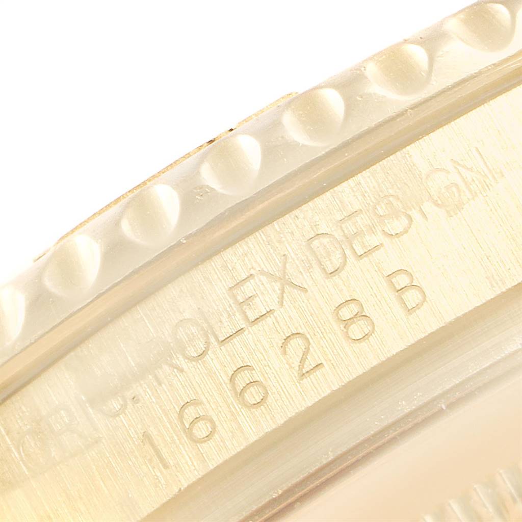 This is a close-up angle of the bezel and engraved edge of the Rolex Yacht-Master 16628 Men's Yellow Gold White Dial 16628 Men's Yellow Gold White Dial watch.