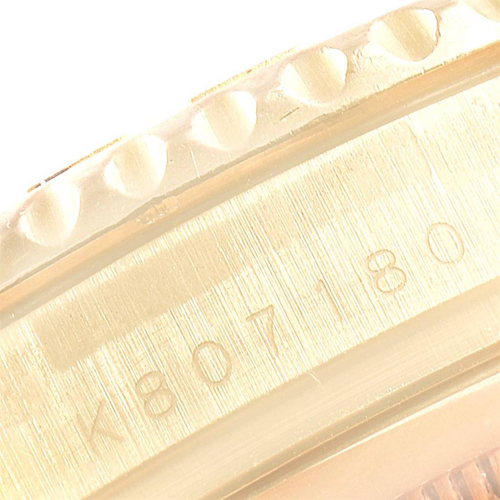 This close-up image shows the case and bezel side of a Rolex Yacht-Master 16628 Men's Yellow Gold White Dial 16628 Men's Yellow Gold White Dial watch, featuring its serial number.