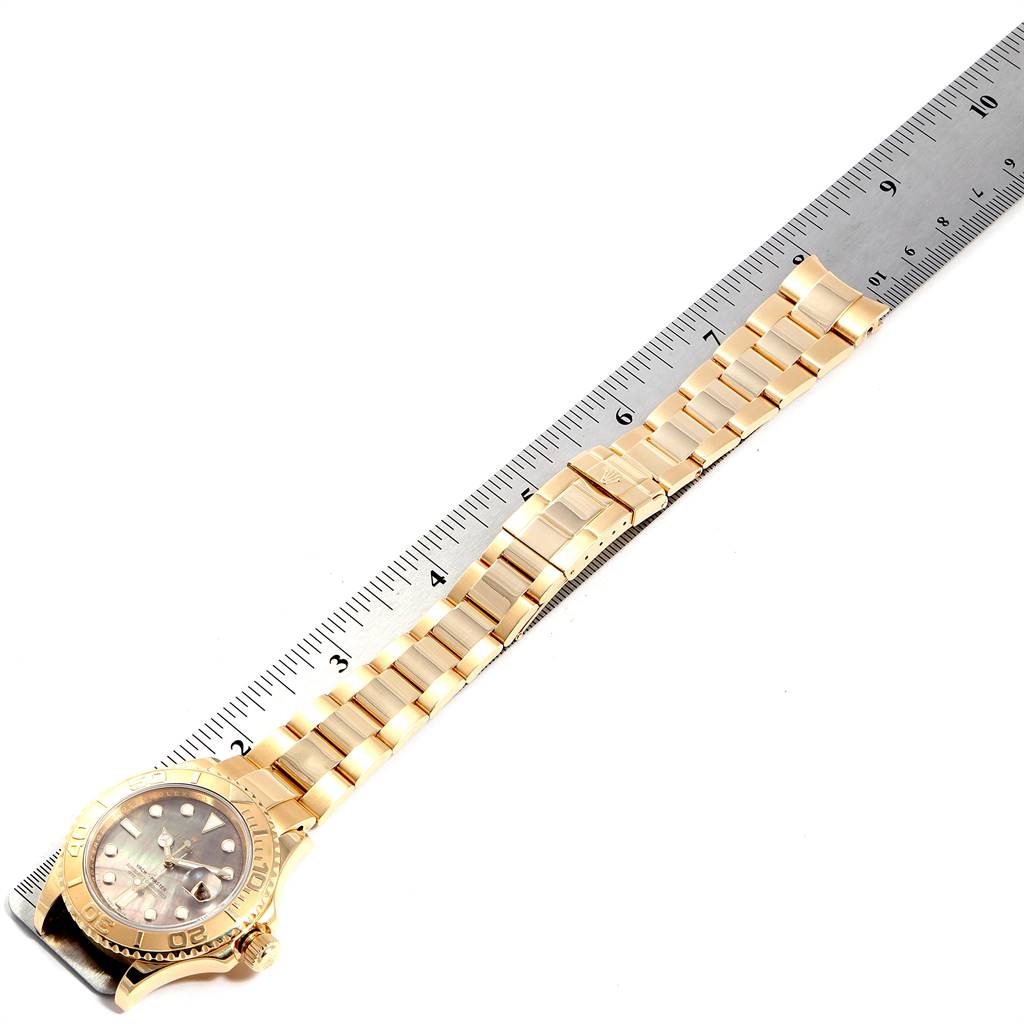 The image shows a top-down view of a Rolex Yacht-Master 16628 Men's Yellow Gold Mother of Pearl Dial 16628 Men's Yellow Gold Mother of Pearl Dial watch, including the face, bezel, crown, and entire bracelet.