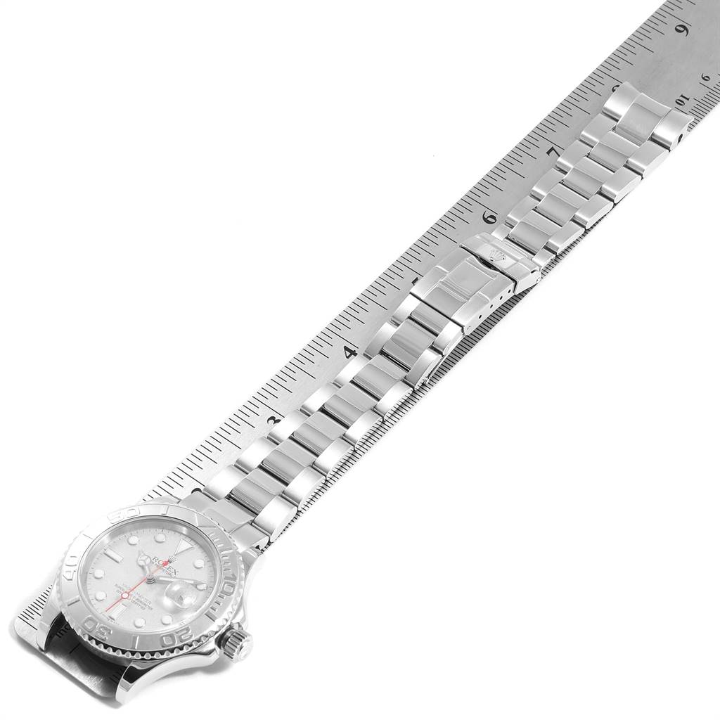 The image shows a side-angle view of a Rolex Yacht-Master 16622 Men
s Stainless Steel Silver Dial 16622 Men
s Stainless Steel Silver Dial watch, displaying its face and metal bracelet, measured against a ruler.