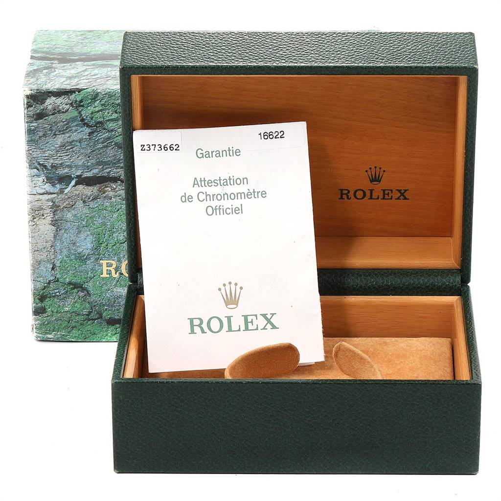 The image shows the open box and warranty papers for a Rolex Yacht-Master 16622 Men
s Stainless Steel Silver Dial 16622 Men
s Stainless Steel Silver Dial watch.