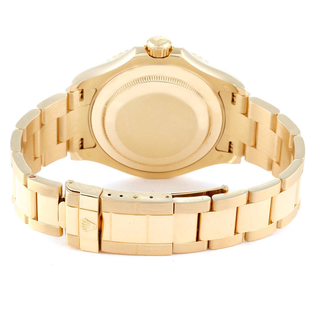 The image shows the back view of a Rolex Yacht-Master 26029 Men
s Yellow Gold Mother of Pearl Dial 26029 Men
s Yellow Gold Mother of Pearl Dial watch, highlighting the case back and the gold bracelet with the clasp.