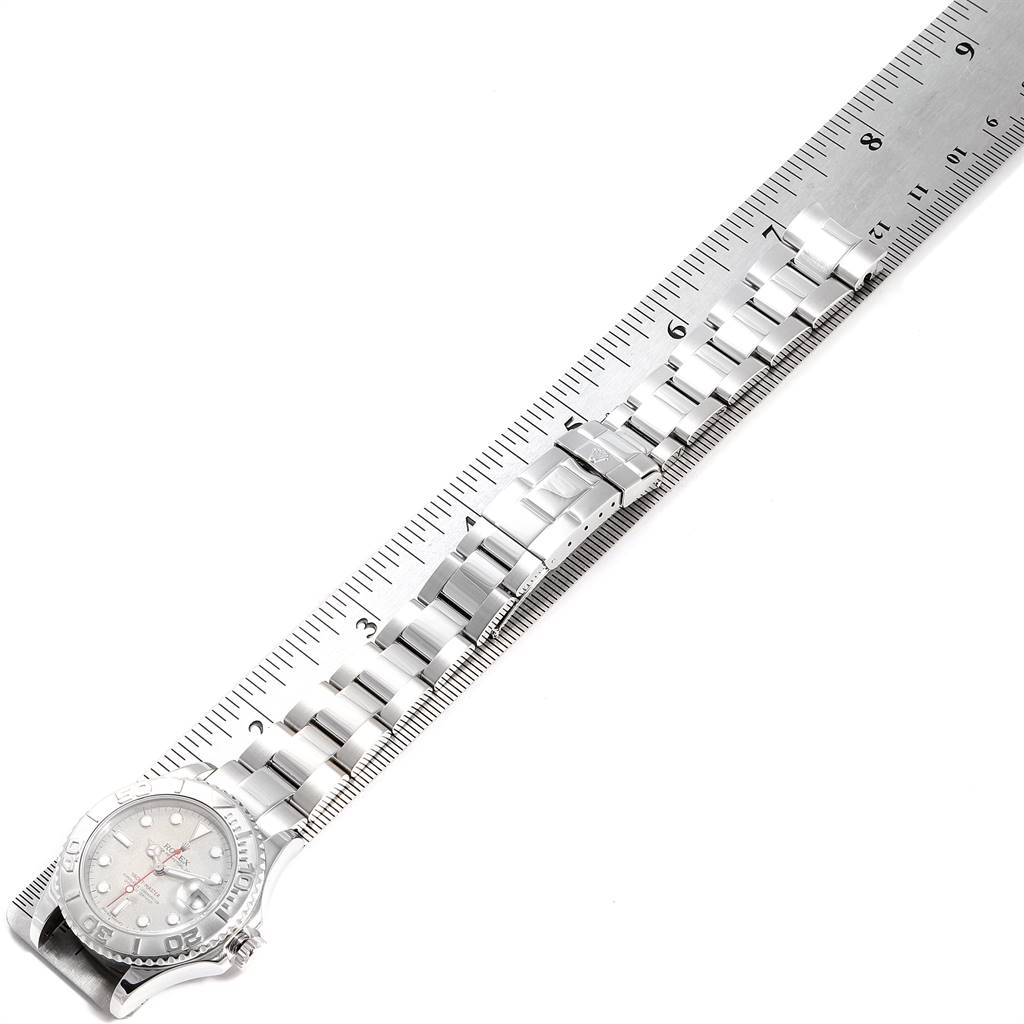 The image shows the Rolex Yacht-Master 168622 Men
s Stainless Steel Silver Dial 168622 Men
s Stainless Steel Silver Dial watch from an overhead angle, highlighting the bracelet laid along a ruler for measurement.