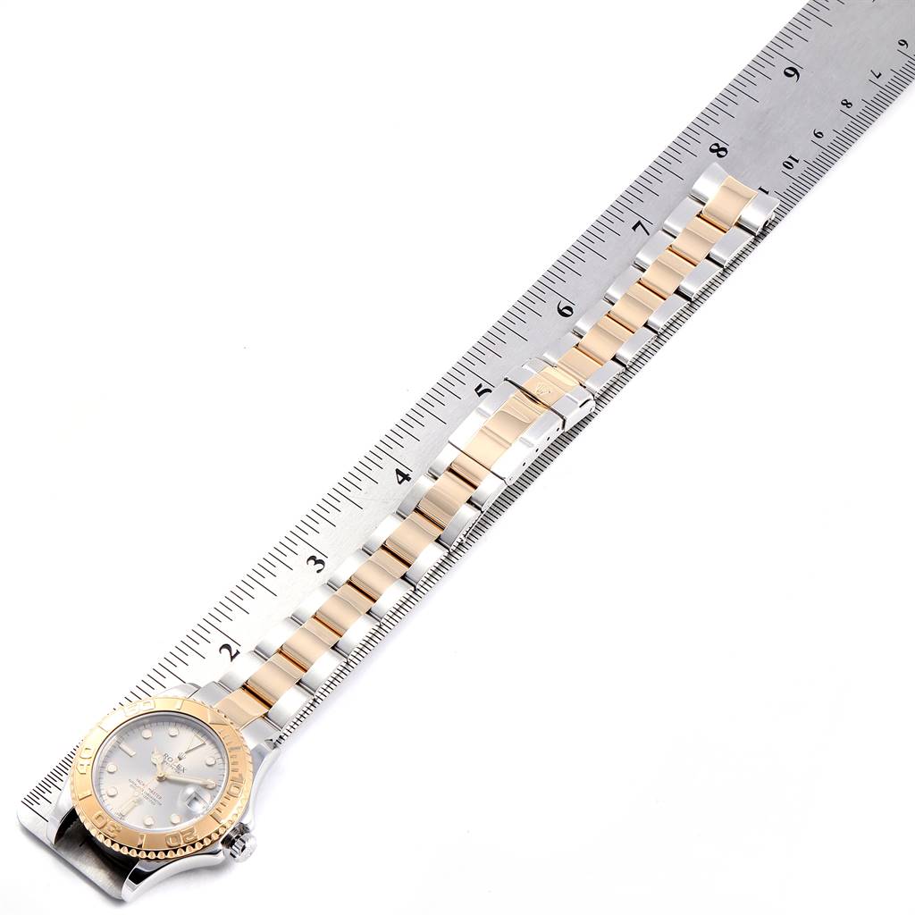 The image shows the Rolex Yacht-Master 168623 Men's Steel and Gold (two tone) Grey Dial 168623 Men's Steel and Gold (two tone) Grey Dial watch from a top view, including the face, bezel, and a partially extended bracelet measured against a ruler.