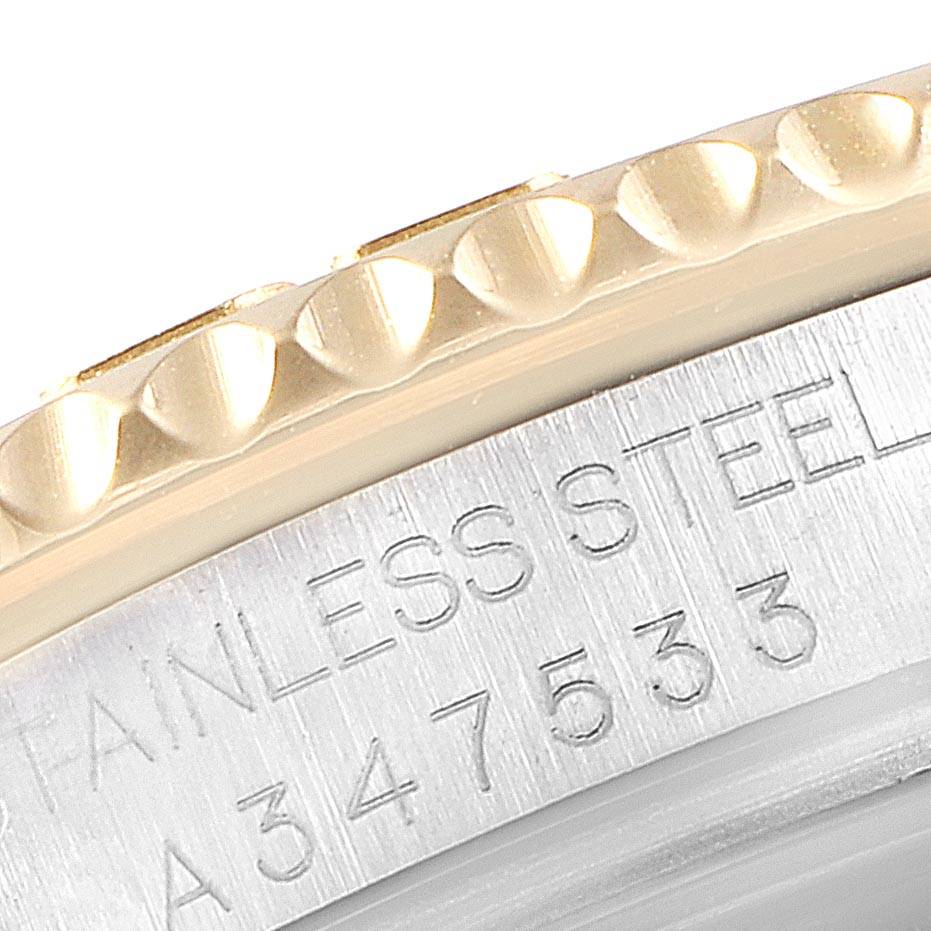 The image shows a close-up of the bezel and case side of a Rolex Yacht-Master 168623 Men's Steel and Gold (two tone) Grey Dial 168623 Men's Steel and Gold (two tone) Grey Dial watch, highlighting the stainless steel marking and part of the serial number.